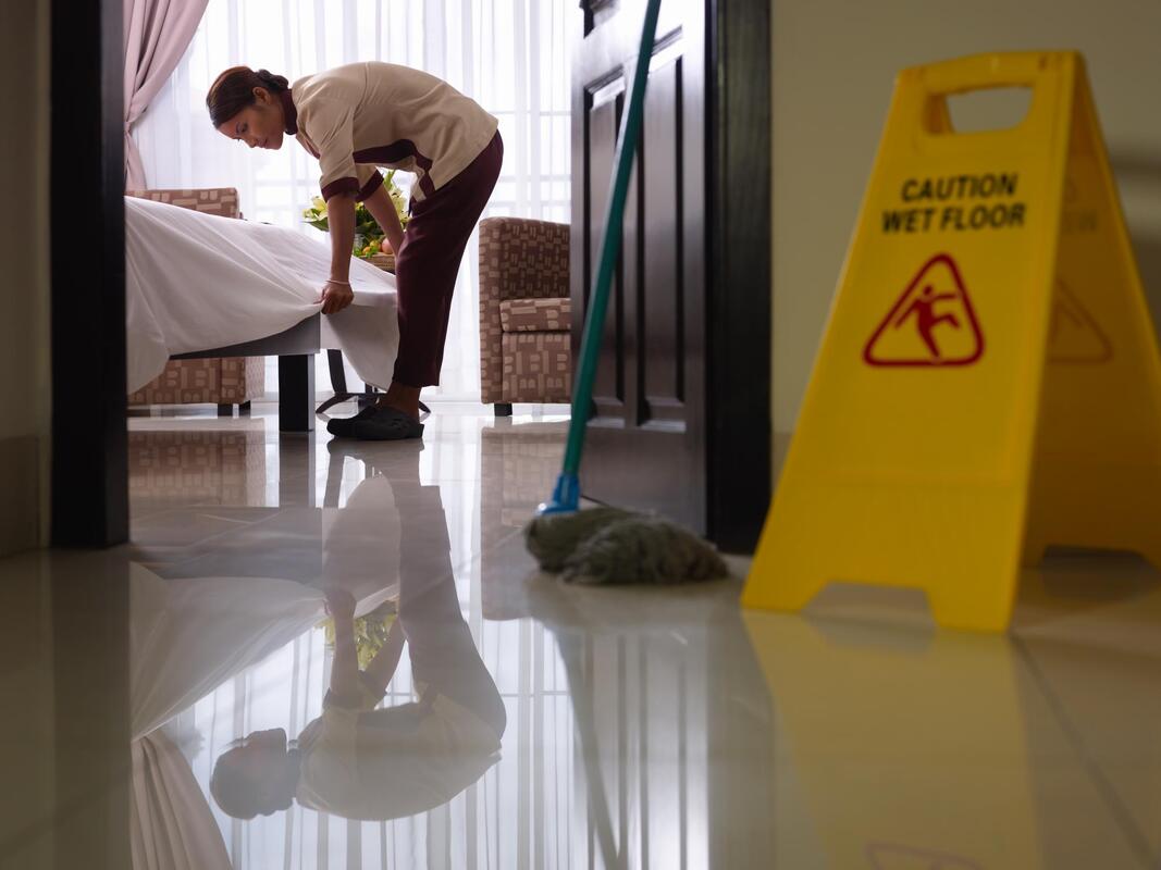 a man is cleaning the floor with a mop