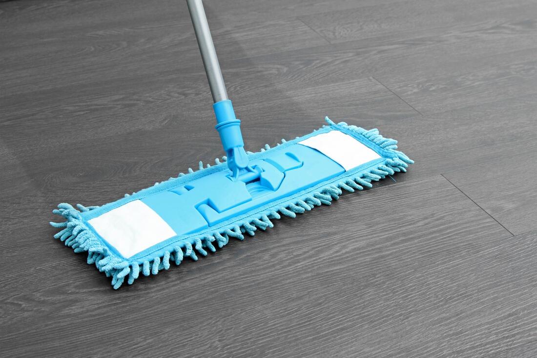 a blue mop is laying on the floor